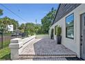 Attractive front porch with brick pavers, clean stucco wall and black framed windows, providing a welcoming entrance at 727 Seminole Ave, Orlando, FL 32804
