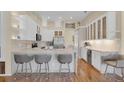 Modern kitchen features white cabinets, stainless steel appliances, and a stylish breakfast bar at 736 Timacuan Blvd, Lake Mary, FL 32746