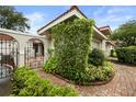 An enclosed courtyard with a garden bed filled with greenery and a brick path at 7528 Chapelhill Dr, Orlando, FL 32819
