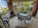 Comfortable balcony with an outdoor table and chairs, ideal for relaxation and enjoying the scenery at 7651 Whisper Way # 201, Kissimmee, FL 34747