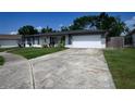 A well maintained one-story home, with a wide driveway, and fresh landscaping at 874 Brevard Ct, Orlando, FL 32822