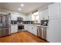 Bright kitchen features stainless steel appliances, white cabinets, and stylish backsplash at 874 Brevard Ct, Orlando, FL 32822