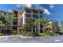A condo building featuring outdoor screened-in patios with landscaped grounds at 9051 Treasure Trove Ln # 505, Kissimmee, FL 34747