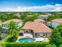 Aerial view of a home with a beautiful backyard pool, spa and outdoor cabana at 9942 Hatton Cir, Orlando, FL 32832