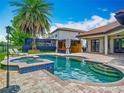 Inviting backyard pool and spa area with a cabana and ample patio space at 9942 Hatton Cir, Orlando, FL 32832
