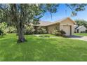 Beautiful single-Gathering home with well-maintained lawn, inviting entrance and mature landscaping at 100 Madden Ave, Sanford, FL 32773
