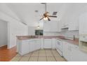 Bright kitchen with white appliances, tiled floor, providing a clean and functional space at 100 Madden Ave, Sanford, FL 32773