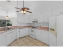 Bright kitchen with white cabinets, and tiled floor, providing a clean and functional space at 100 Madden Ave, Sanford, FL 32773