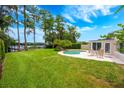Backyard pool area with a well maintained lawn and access to the lake at 1018 Turner Rd, Winter Park, FL 32789