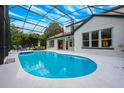 Sparkling screened-in pool features inviting lounge area and ample space for outdoor entertaining in the Florida sunshine at 10241 Pointview Ct, Orlando, FL 32836