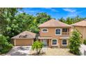 Well-maintained two-story home with a detached garage and a beautifully landscaped front yard at 1046 Morris Ave # 1046, Orlando, FL 32803