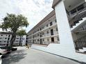 A low angle view of a condo building with private balconies and fresh exterior paint at 118 S Halifax Ave # 409, Daytona Beach, FL 32118