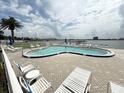 Beautiful waterfront pool area with comfortable lounge seating perfect for relaxing and enjoying the scenic view at 118 S Halifax Ave # 409, Daytona Beach, FL 32118