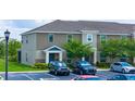 Stylish townhomes boast neutral siding, manicured lawns, and convenient parking spaces at 130 Claire Ln, Davenport, FL 33837