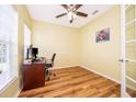 Home office with wood floors, a ceiling fan, and a desk with computer at 1415 Ellis Fallon Loop, Oviedo, FL 32765