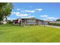 Charming single-story home with a well-manicured lawn and brick driveway at 142 Florence Blvd, Debary, FL 32713