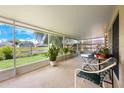 Spacious screened-in lanai with tile flooring, overlooking a tranquil pond, perfect for outdoor living and relaxation at 14224 Colonial Lakes Dr, Orlando, FL 32826