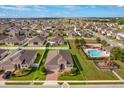 Aerial view of a home with a community pool and playground at 147 Seville Dr, Davenport, FL 33837