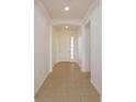 Bright foyer with tile flooring leading to the front door with sidelights at 147 Seville Dr, Davenport, FL 33837