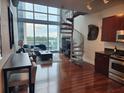 Bright living room features a spiral staircase, hardwood floors, and modern kitchen at 150 E Robinson St # 419, Orlando, FL 32801
