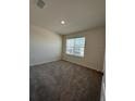 Cozy bedroom with plush carpeting and a window providing natural light at 1727 Buckeye Rd, Davenport, FL 33837
