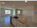 Open kitchen with a large island featuring a sink and stainless steel appliances at 1727 Buckeye Rd, Davenport, FL 33837