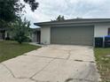 Attached two-car garage with a spacious driveway for easy parking at 1812 Firwood Ct, Orlando, FL 32818
