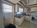Cozy kitchen featuring classic white cabinets and tile flooring at 1812 Firwood Ct, Orlando, FL 32818