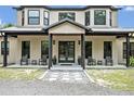 Inviting home with a covered front entrance, featuring sleek seating arrangements and modern decor at 2459 Mcgregor Oaks Ln, Deland, FL 32720