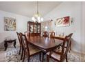 Formal dining room featuring a large wooden table, elegant decor, and ample natural light at 2625 Eagle Cliff Dr, Kissimmee, FL 34746