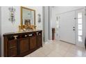 Inviting foyer showcases tiled flooring and a decorative console table with ornate mirror and candle display at 2625 Eagle Cliff Dr, Kissimmee, FL 34746