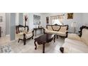 Elegant living room featuring traditional-style furniture, decorative accents, and a light-filled ambiance at 2625 Eagle Cliff Dr, Kissimmee, FL 34746