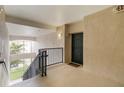 Hallway entrance featuring a staircase, a dark-colored door and an 'EXIT' sign at 3000 Laurel Park Ln # 308, Kissimmee, FL 34741