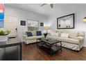 Inviting living room with hardwood floors, neutral walls, comfortable seating, and lots of natural light at 3203 Oyster Ln, Kissimmee, FL 34747