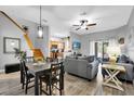 Open living space with stairs, wood floors, and access to the kitchen at 3214 Calabria Avenue, Davenport, FL 33897