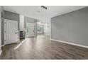 Modern entryway with wood floors, neutral paint, statement light fixture and lots of natural light at 3824 Blue Dasher Dr, Kissimmee, FL 34744