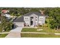 Charming two-story home with landscaped yard, black roof, neutral paint and two car garage at 3824 Blue Dasher Dr, Kissimmee, FL 34744