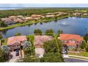 Stunning aerial view of a home with a serene lake and lush greenery at 3904 Coastal Breeze Dr, Kissimmee, FL 34744