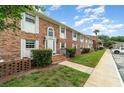 Inviting brick townhouse showcasing a well-maintained lawn and lush landscaping at 4300 Lake Underhill Rd # D, Orlando, FL 32803