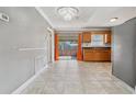 Open-concept kitchen with wood cabinets, stainless steel appliances, and tile floors at 510 Peach Tree Ln, Altamonte Springs, FL 32701