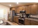 Modern kitchen featuring stainless steel appliances, granite countertops, and ample cabinet space at 5416 Tessin Trl, St Cloud, FL 34771