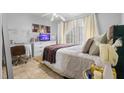 Cozy bedroom features a well-lit desk area, comfortable bed, and serene decor at 621 Bluebill Ln, Poinciana, FL 34759