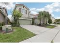 Charming two-story home with well-manicured lawn and two car garage at 7033 Oakwood St, Davenport, FL 33837
