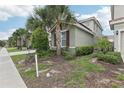 Exterior showcasing landscaped front yard with palm trees at 7033 Oakwood St, Davenport, FL 33837