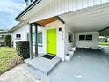 Stylish home featuring a vibrant green front door with contemporary design elements at 714 28Th St, Orlando, FL 32805