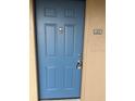 A light blue, four-panel front door with a silver door knocker, and the apartment number '234' at 7350 Westpointe Blvd # 234, Orlando, FL 32835