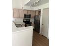A kitchen with light wood cabinets and stainless steel appliances provides a modern space at 7350 Westpointe Blvd # 234, Orlando, FL 32835