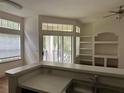 Living space with built-in shelving and access to a private balcony at 7350 Westpointe Blvd # 234, Orlando, FL 32835