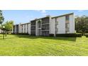 Exterior showcasing meticulously maintained landscaping and architecture of the condo building at 8211 Sun Spring Cir # 11, Orlando, FL 32825