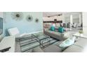 Cozy living room showcases modern decor, a large sofa, a decorative rug, and a view into the kitchen at 8986 Cabot Cliffs Dr, Davenport, FL 33896